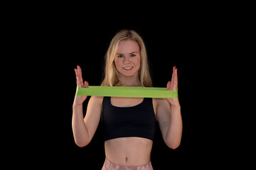 Smiling Pretty Girl Holding Green Resistance Band for Fitness on Black Background