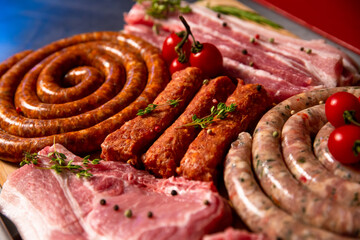 Close up delicious meat table layout raw steaks and sausages. Premium organic meat to sell in market. Meat industry concept.