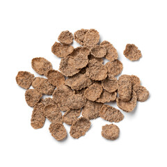 Heap of dried buckwheat flakes isolated on white background close up