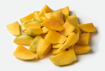 pile of chopped ripe mango isolated white background, vibrant yellow juicy fruit pieces to prepare mixed fruit salads or smoothies