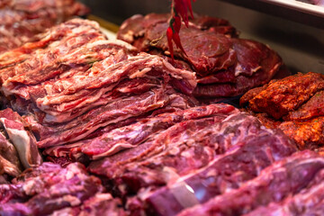 Large amount of lamb meat on display in a butcher shop. Selection of meat in a store.