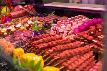 Close up traditional turkish raw kebab in a window shop for sale. Turkish cuisine on tray for display in a market. Food industry concept.