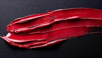 close up of a red lipstick marks on black surface