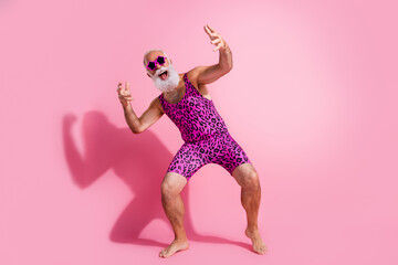 Full size photo of glamour senior man dance disco excited wear leopard print swimsuit isolated pink color background