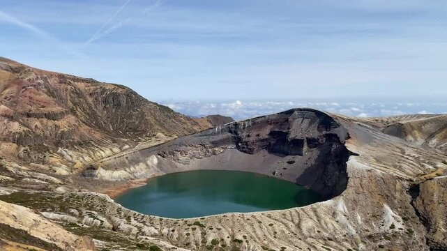 Okama Crater Lake on the sunny day. While local people call it affectionately Okama, the visitors tend to call it "Five Color Pond", because its color changes.