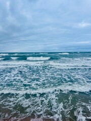 Cloudy seascape, seashore waves, natural sea horizon, cloudy sky