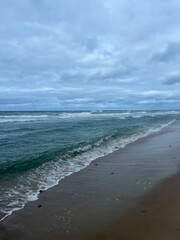 Cloudy seascape, seashore waves, natural sea horizon, cloudy sky
