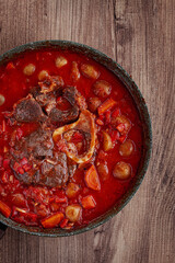 ossobuco stew with vegetables, knuckle on the bone with new potatoes, in tomato sauce,homemade, top view, no people,