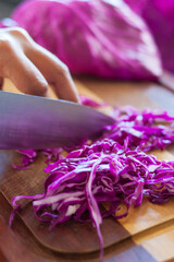 Chef preparing a red cabbage salad.