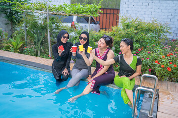 Friends gather by the pool, enjoying colorful drinks and celebrating their friendship in summer