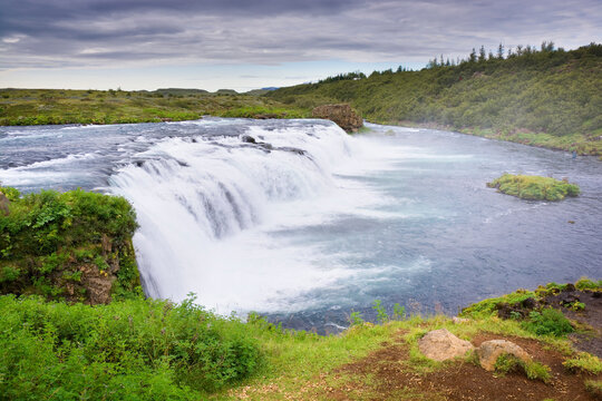 Faxafoss Waterfall (Faxi) against dark stormy sky, Iceland