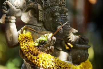 Sculpture of a temple with flowers and incense for ritual offerings on the popular tourist island of Bali.