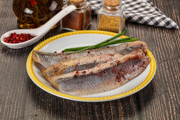 Salted marinated herring fillet with spices