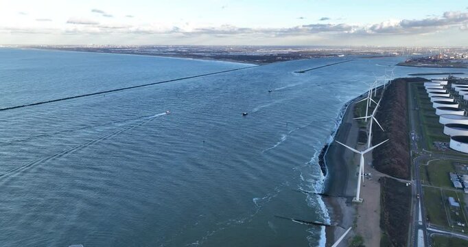 An aerial drone video of a large container ship entering port of Rotterdam at the Maasvlakte.