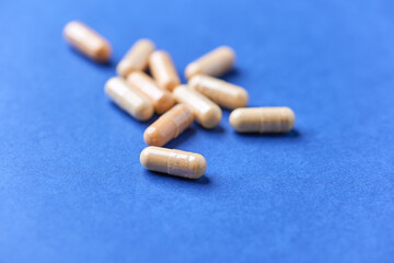 Lutein capsules. Dietary supplement on bright background. Soft focus. Close up. Copy space