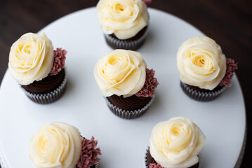 chocolate cupcakes with buttercream frosting on plate