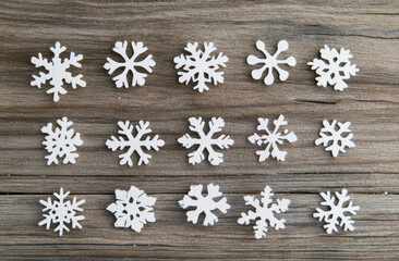 White snowflakes on a wooden background, a Christmas decoration concept