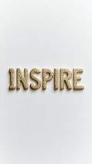 Inspire: A simple, yet powerful message crafted from golden letters, sparking a sense of motivation and purpose.  