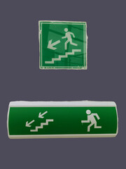 Green emergency exit sign with a man climbing up on the stairs.