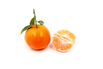 A whole and peeled piece of clementine or tangerine isolated on a white background.