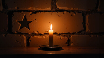 Single candle casting star-shaped shadows on a rustic wall