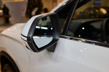 An elegant closeup shot of a sleek car side mirror showcasing its design and details