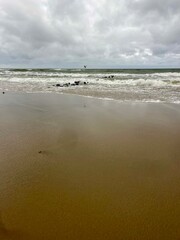cloudy seascape, sandy shore, empty wild beach, clouds and waves