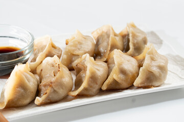 Dumplings with meat on a white background. Chinese dumplings are a traditional dish for Chinese New Year. Food concept. Chinese food.