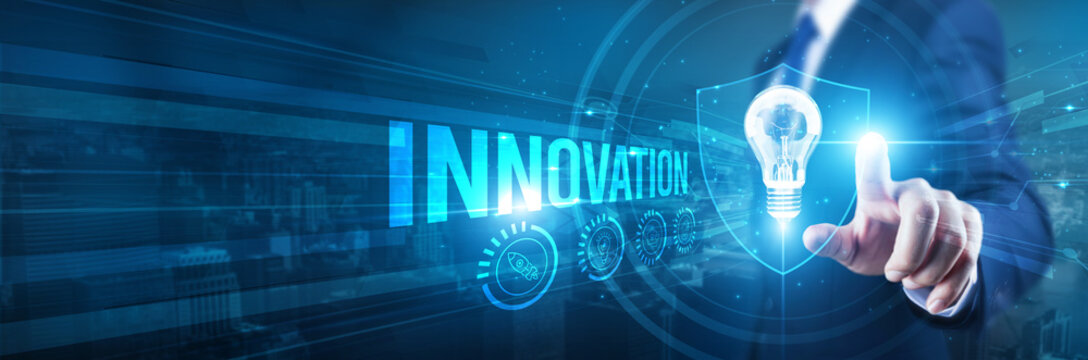 Businessman hand touches a shield, Innovation is protected by intellectual property. The concept represents safeguarding intellectual property rights, trade secrets, patents, trademarks, copyrights.