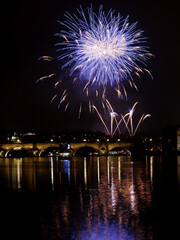 New Year's colorful fireworks with reflection on the river surface, festive mood