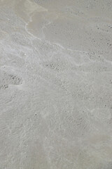 Pouring concrete monolith from a machine. Selective focus.