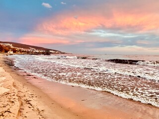 colorful sunset over the sea is reflected in the water