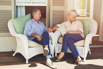 Elderly couple, holding hands and relax in home with love, bonding or trust on patio chairs. Marriage, senior people or support on porch with retirement comfort, sharing memories or relationship care