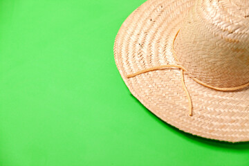 Straw sombrero on green background. Sombrero concept. Hat concept. copy space.