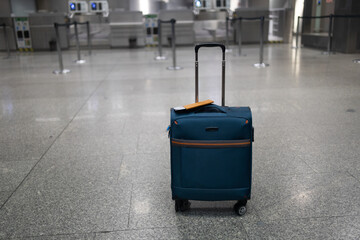 Travel accessories costumes for the tripimage, one suitcase in an empty airport hall, traveler case in the departure airport terminal waiting for the area, vacation concept, blank space for text