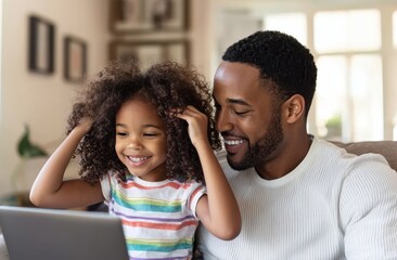 Father and daughter enjoying a joyful moment together on the couch as they share a tender, happy interaction in the cozy living room while spending quality family time.