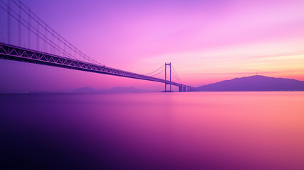 Suspension Bridge Spanning Calm Waters During Vibrant Twilight Sky.