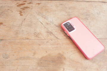 Smartphones 2
Pink smartphone on wooden pattern background