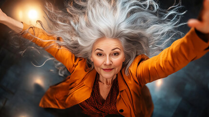 Banner depicts gray-haired woman defying gravity with exuberant expression flying across vivid light beams