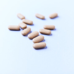 Ashwagandha (Withania somnifera) tablets on paper background. Soft focus. Close up. Copy space.	