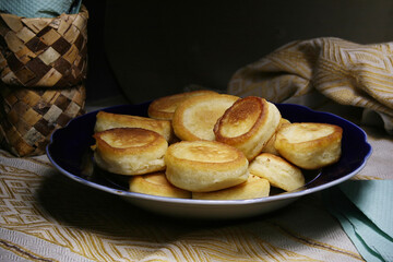 A plate of ruddy fresh pancakes is on the table