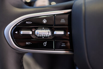 Fototapeta premium The modern cars steering wheel control panel boosts convenience and performance