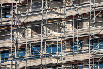 Close-up with a scaffolding on the facade of a block