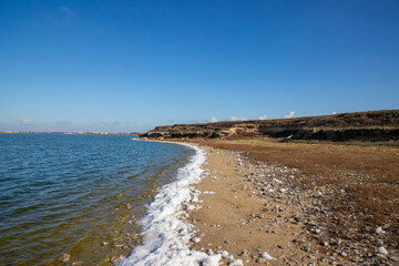 Landscape with white foam on the shore of Lake Techirghiol in Constanta County - Romania