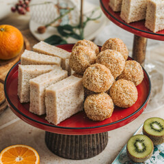 Traditional Chinese New Year, Delicious dessert platter featuring sweet coconut squares and sesame balls.