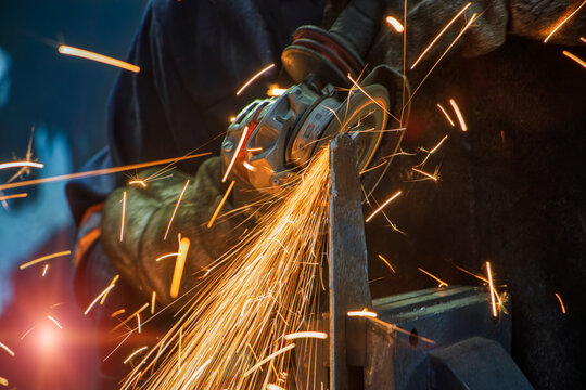 angle grinder and sparks, metal worker grinding a piece of metal