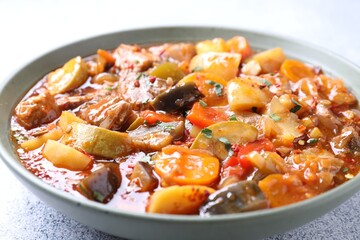 Delicious stew with vegetables in bowl on table, closeup