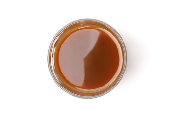 Tasty caramel sauce in glass bowl isolated on white, top view