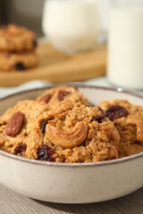 Delicious oatmeal cookies with raisins and nuts on table, closeup