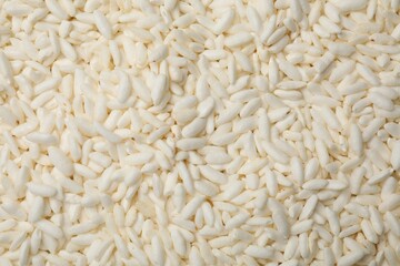 Wholegrain puffed rice as background, closeup view